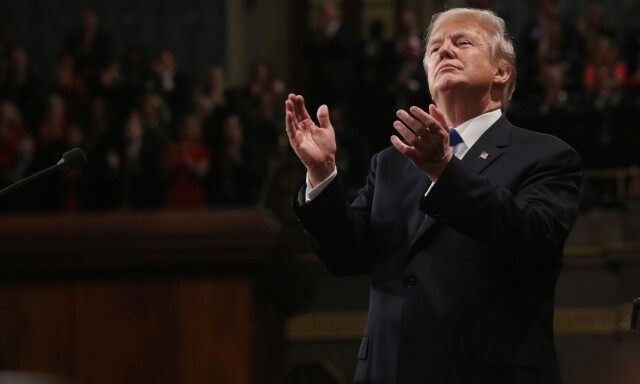 U.S. President Donald Trump applauds during his first State of the Union address to a joint session of Congress inside the House Chamber on Capitol Hill in Washington, U.S., January 30, 2018. REUTERS/Win McNamee/Pool TPX IMAGES OF THE DAY